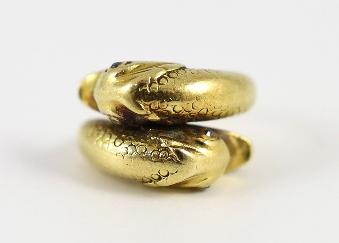 An early 20th century continental gold and diamond chip set twin dolphin crossover ring